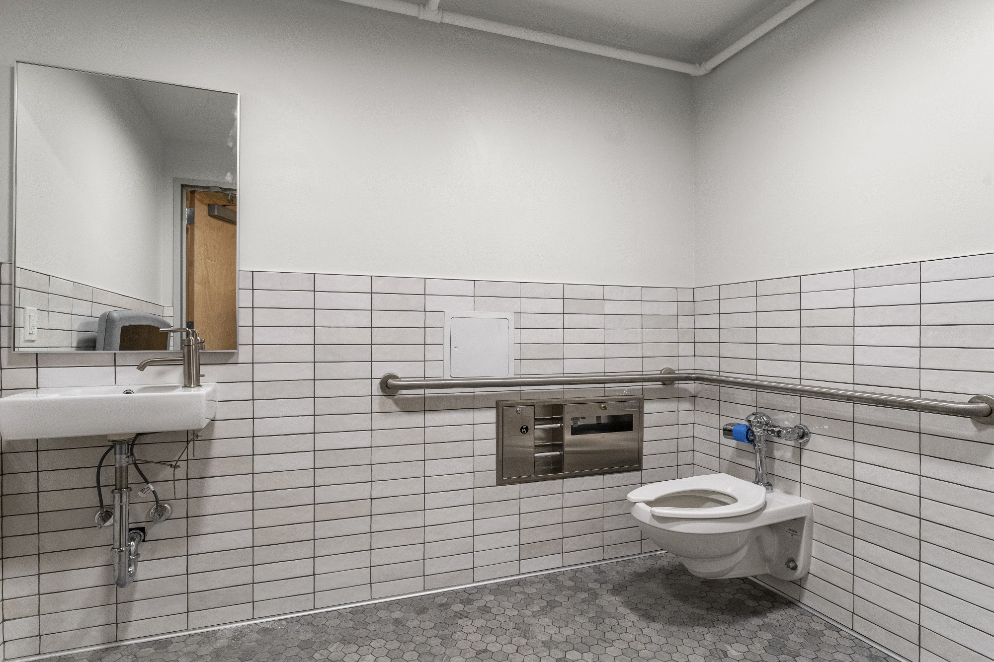 Finished tiled bathroom with shower, toilet and vanity fixtures